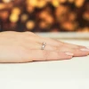 Elegancki pierścionek zaręczynowy z białego złota z brylantem, prezentowany na dłoni z subtelnym manicure produktu W0178.B3.DIW.02