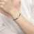 Bransoletka z pozłacaną mapą świata na czarnym sznurku Animo B312-925_CZZ marko