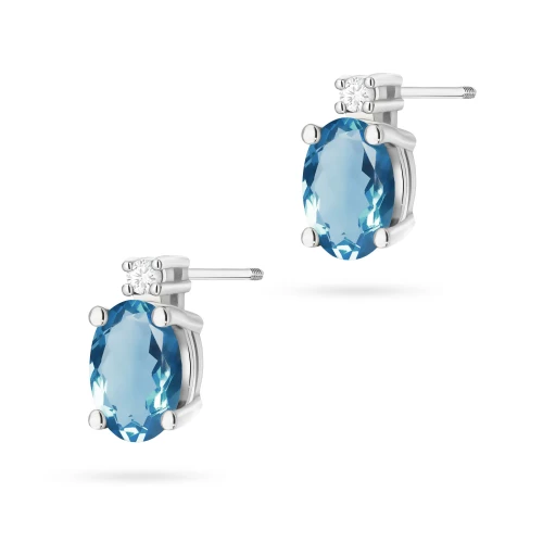 Kolczyki z białego złota z brylantami  i owalnym topazem London Blue sztyft zakręcany labret