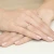 Pleciony złoty pierścionek z cyrkoniami, prezentowany na dłoni z delikatnym manicure produktu W0096.Z3.DIW.01